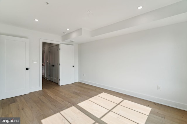 empty room with light hardwood / wood-style flooring