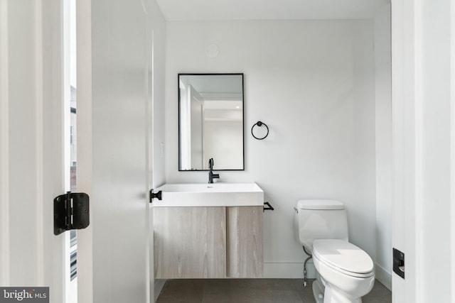 bathroom with toilet and vanity