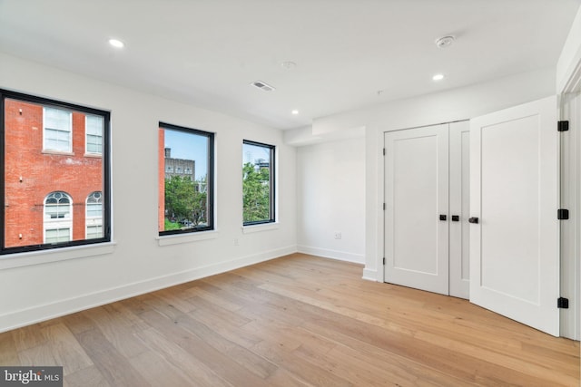 unfurnished bedroom featuring light wood-type flooring