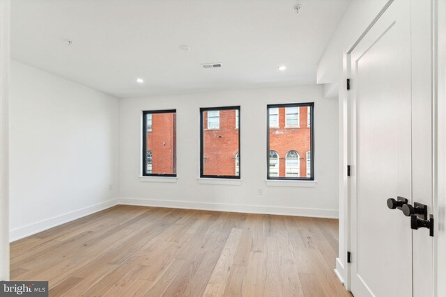 unfurnished room with light wood-type flooring