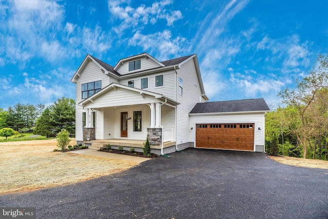 craftsman-style house featuring a porch and a garage