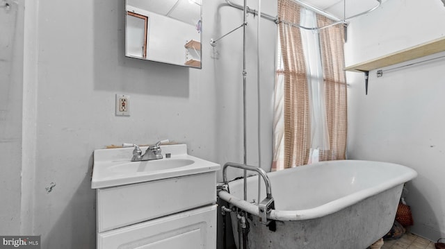 bathroom featuring a bathing tub, tile floors, and oversized vanity