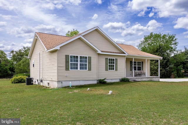 view of front of home with central air condition unit, a front lawn, and a porch