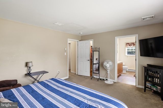 bedroom featuring ensuite bathroom, light colored carpet, and baseboard heating