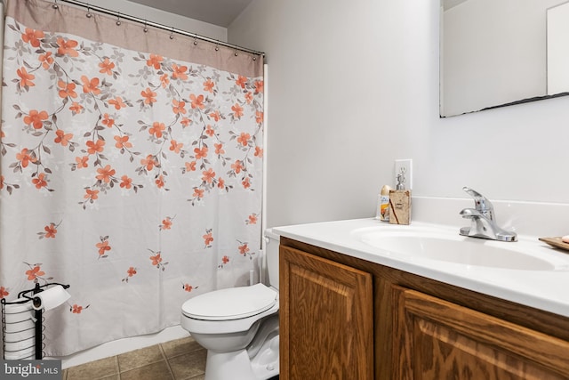 bathroom featuring toilet, vanity, and tile patterned floors