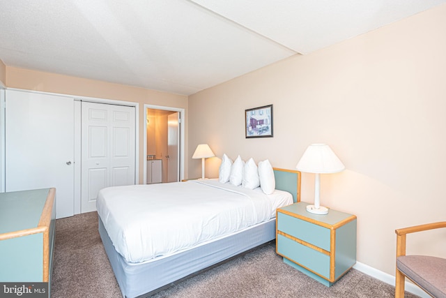 bedroom with a closet and dark colored carpet