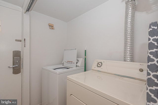 washroom with washing machine and clothes dryer