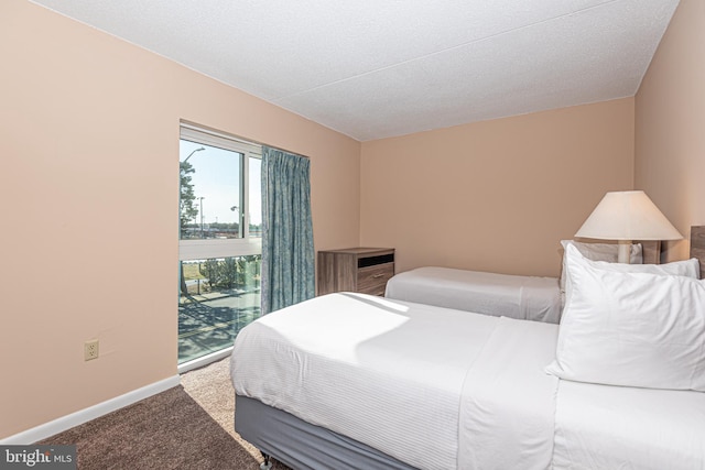 bedroom with carpet floors and a textured ceiling