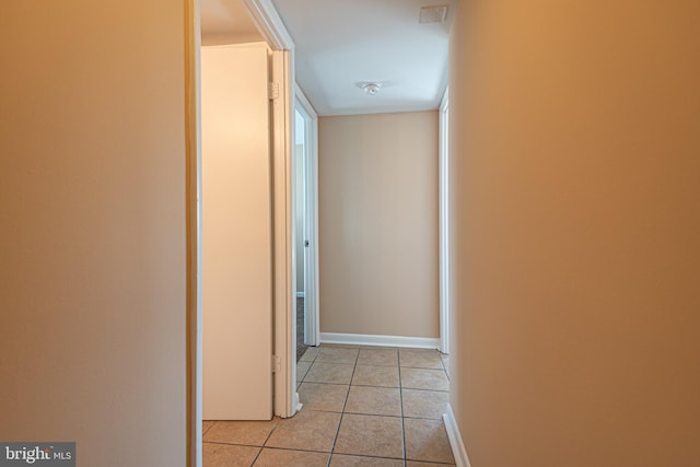 corridor featuring light tile floors