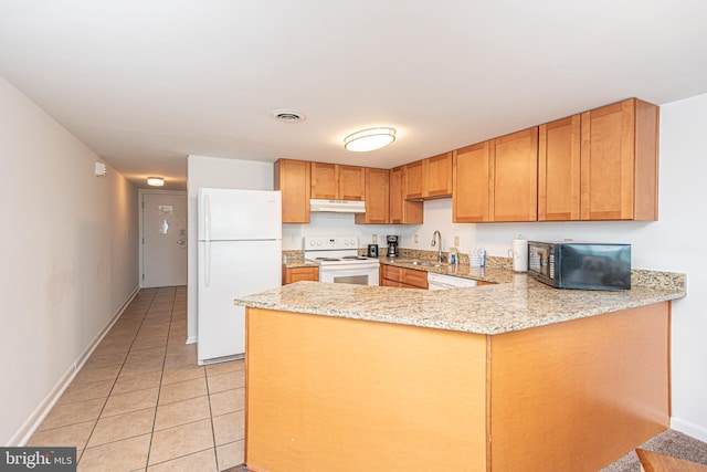 kitchen featuring light stone counters, light tile floors, kitchen peninsula, white appliances, and sink