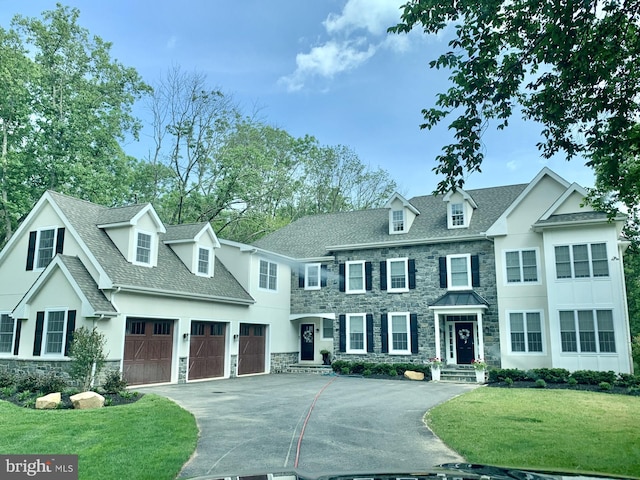 view of front of property with a front lawn and a garage