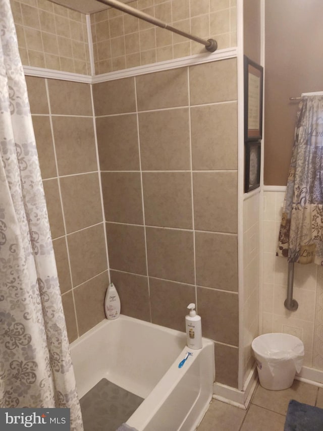 bathroom featuring tile flooring and shower / bath combo with shower curtain