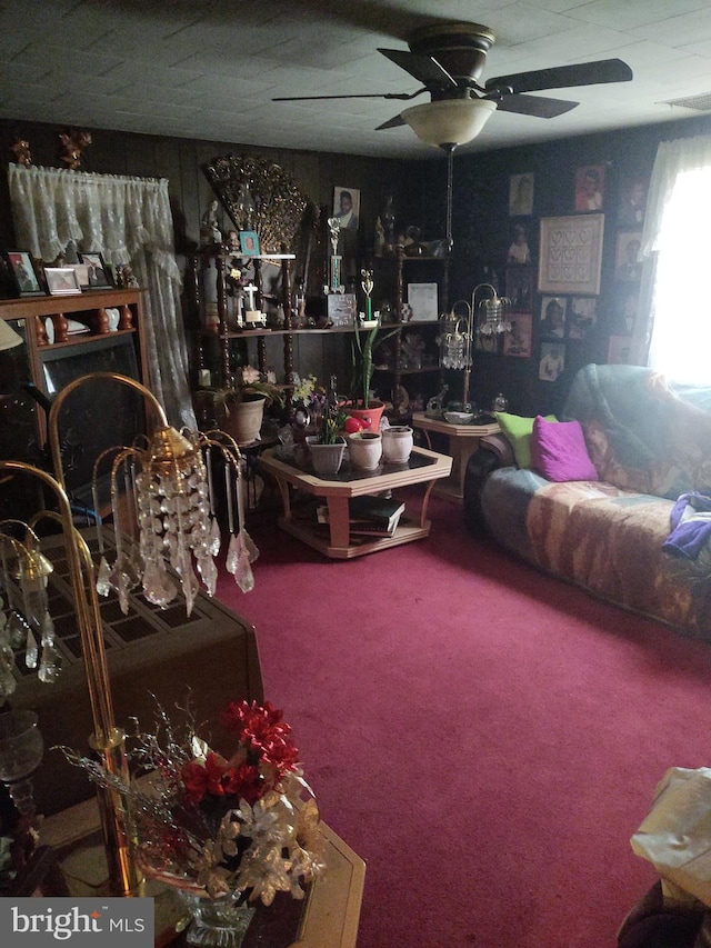 carpeted living room with ceiling fan