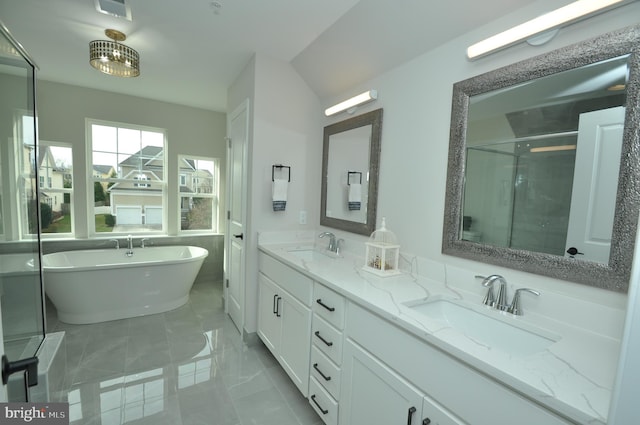 bathroom featuring shower with separate bathtub and vanity