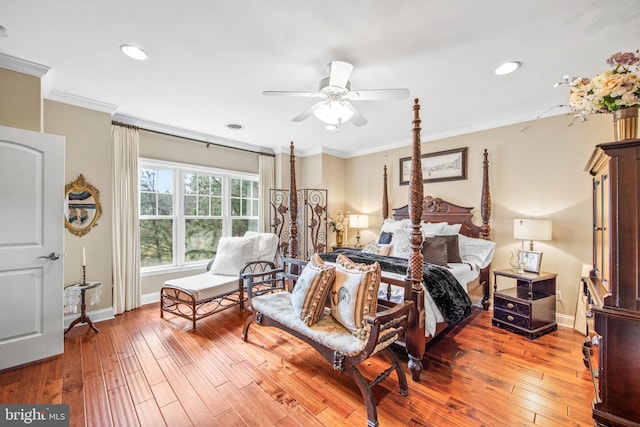 bedroom featuring ceiling fan, crown molding, and light hardwood / wood-style flooring