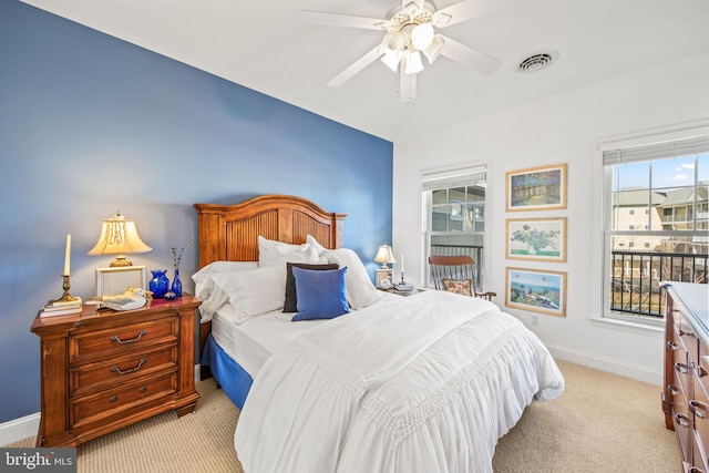 bedroom with ceiling fan and light colored carpet