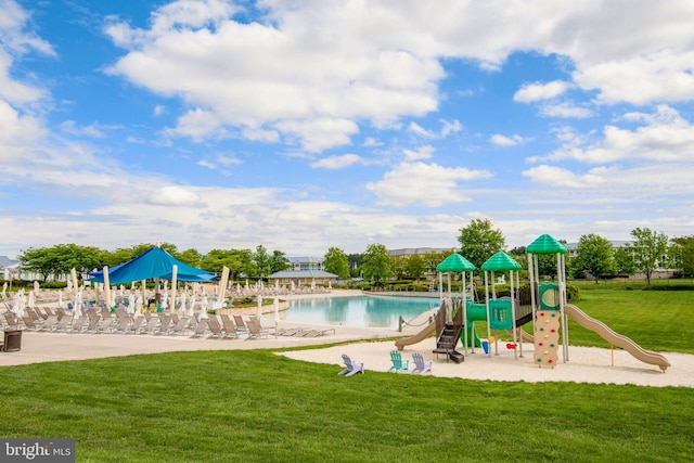 view of play area featuring a lawn and a community pool