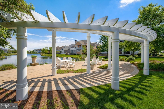 exterior space featuring a water view and a pergola