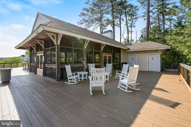 wooden deck featuring a sunroom