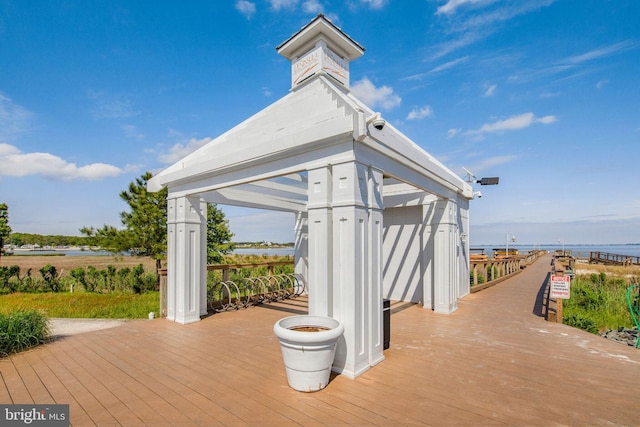 wooden deck featuring a gazebo and a water view