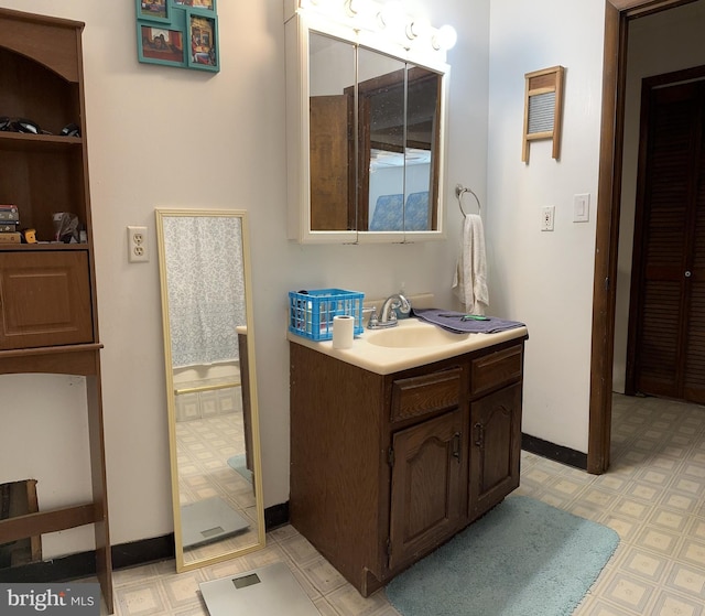 bathroom with tile floors and vanity with extensive cabinet space