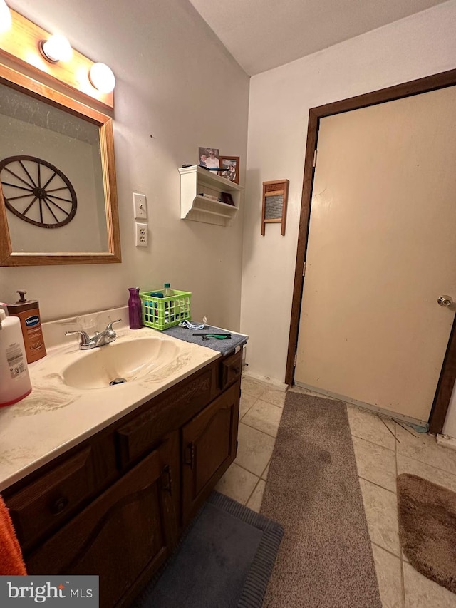 bathroom featuring tile flooring and vanity