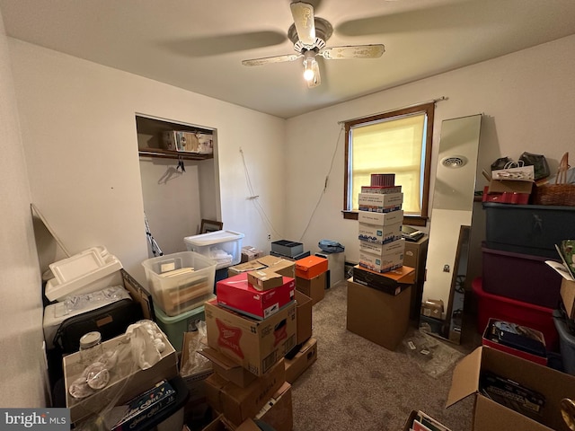 carpeted office space with ceiling fan