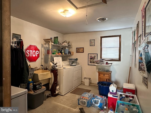 washroom with independent washer and dryer and sink