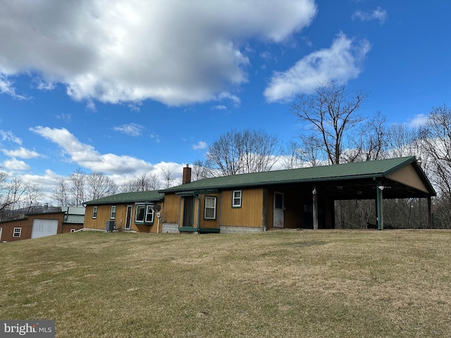 rear view of property featuring a yard