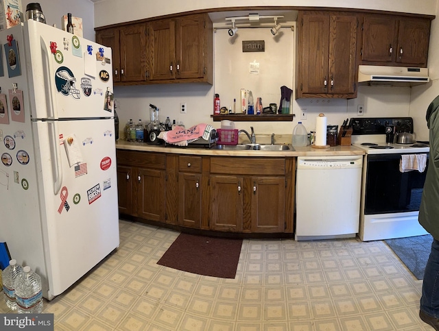 kitchen with light tile flooring, white appliances, and dark brown cabinets