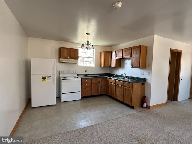 kitchen featuring hanging light fixtures, white appliances, sink, light colored carpet, and a chandelier