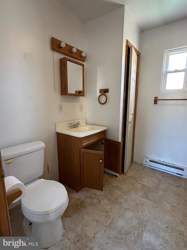 bathroom featuring vanity, tile floors, a baseboard heating unit, and toilet