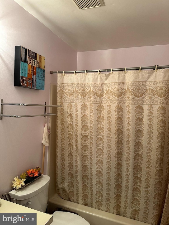 bathroom with toilet and shower / bath combination with curtain