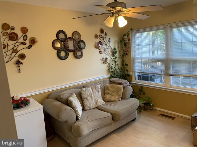 living room featuring ceiling fan and light wood-type flooring