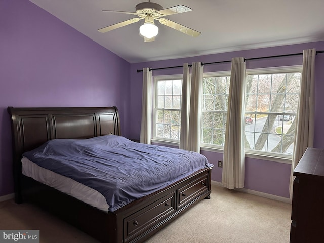 carpeted bedroom featuring ceiling fan and vaulted ceiling