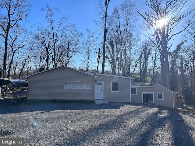 view of front of property featuring a carport