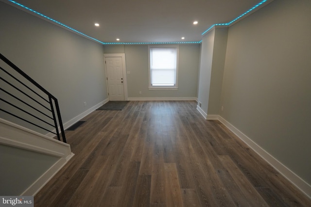 spare room featuring dark hardwood / wood-style flooring and ornamental molding