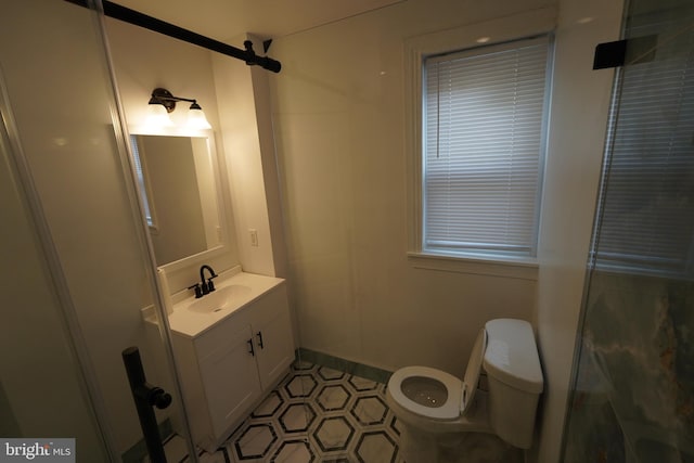 bathroom featuring vanity, tile flooring, and toilet