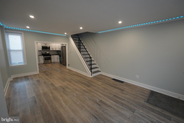 unfurnished living room with dark hardwood / wood-style flooring