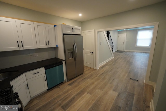 kitchen featuring white cabinetry, wood-type flooring, sink, and stainless steel appliances