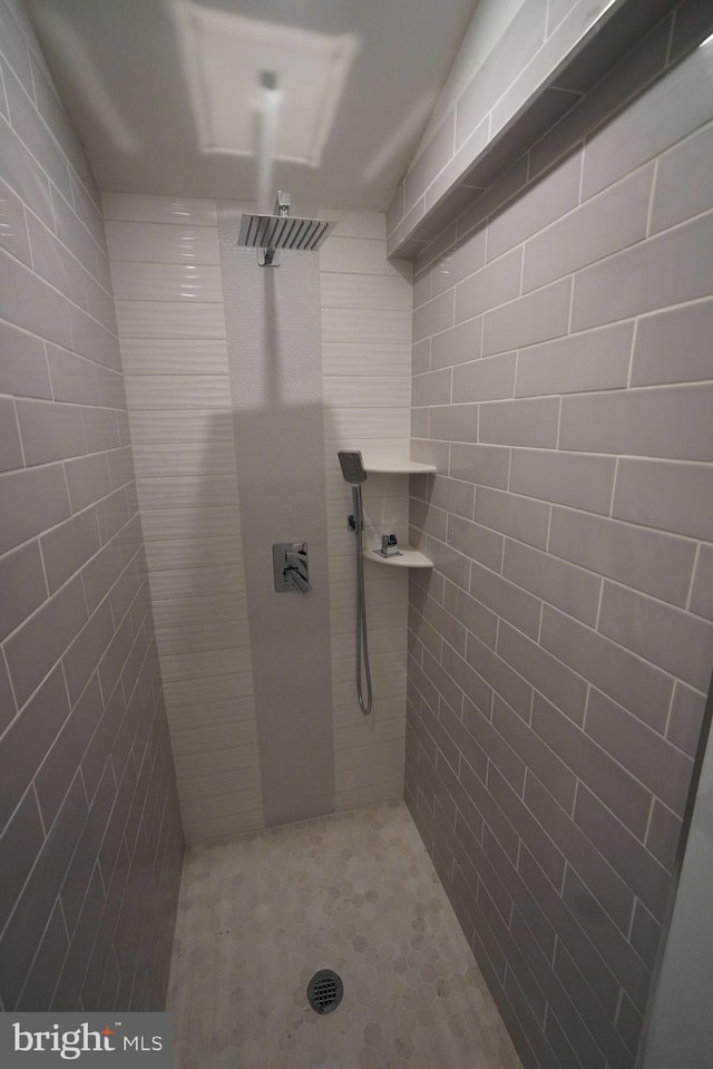 bathroom with tiled shower