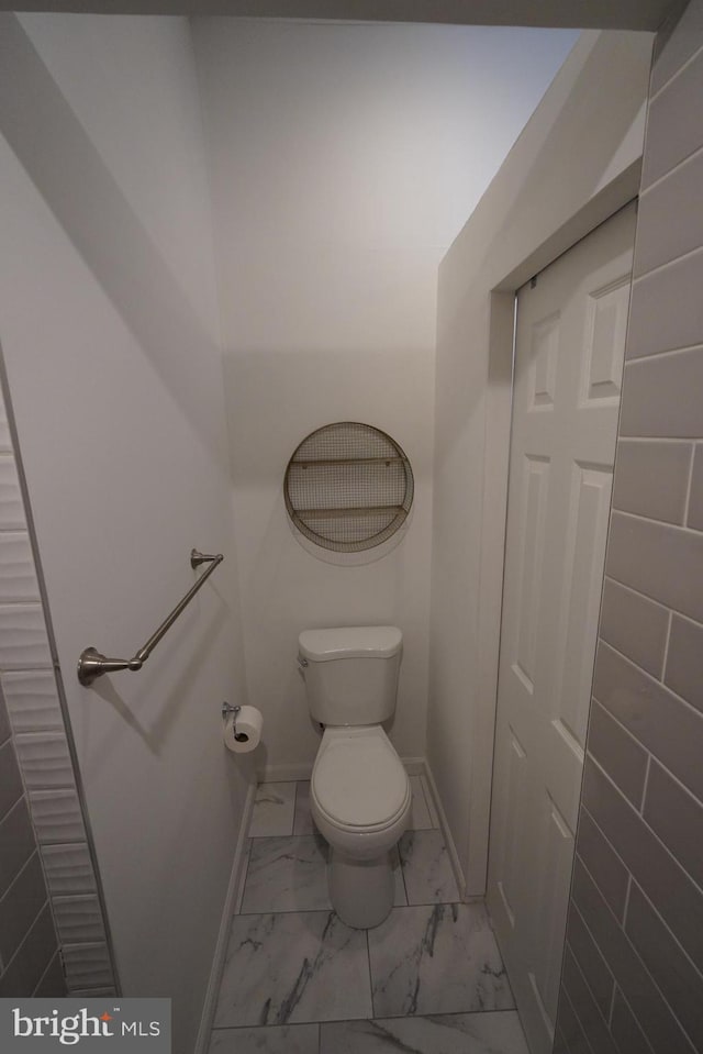 bathroom with tile flooring and toilet