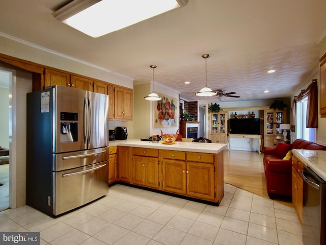 kitchen with ornamental molding, kitchen peninsula, ceiling fan, and stainless steel appliances