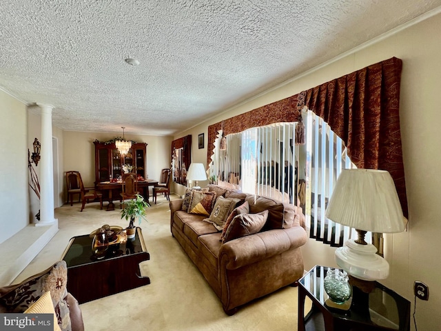 living room featuring a textured ceiling, light carpet, a chandelier, and ornate columns