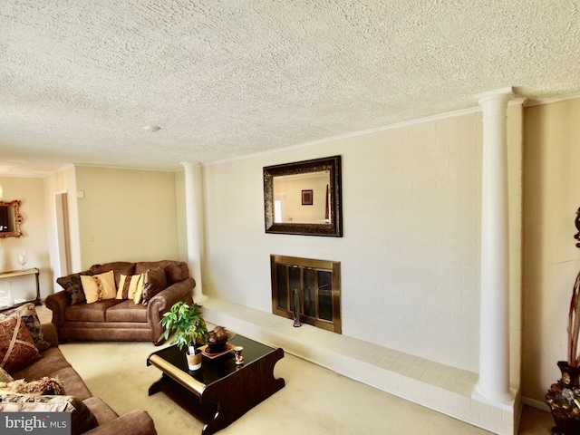 living room with ornate columns, light colored carpet, a brick fireplace, and a textured ceiling