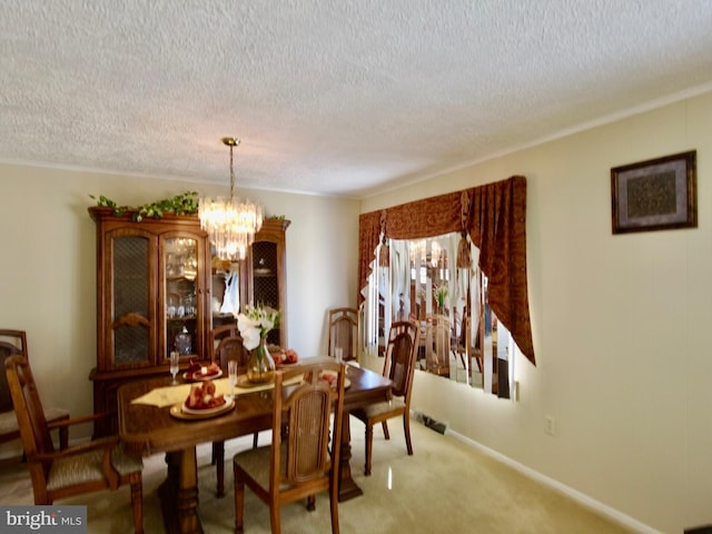 carpeted dining space with a chandelier and a textured ceiling