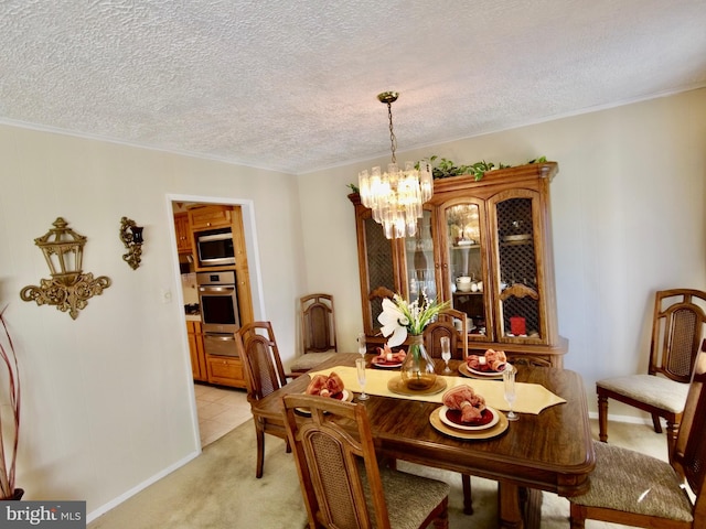 dining area featuring an inviting chandelier, light carpet, and a textured ceiling