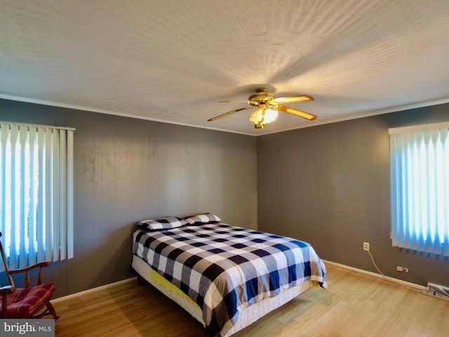 bedroom with ceiling fan and light hardwood / wood-style flooring