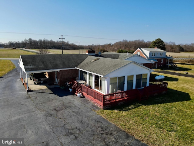 view of front of house featuring a front lawn and a carport