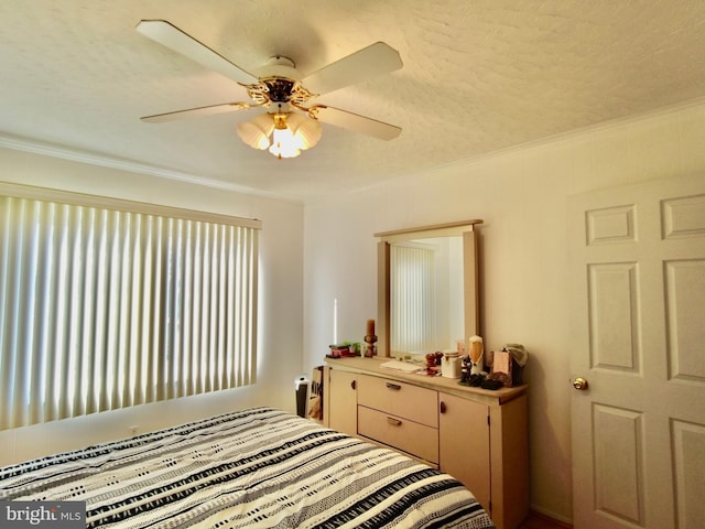 bedroom with a textured ceiling and ceiling fan